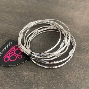 A set of 9 faux silver bengals. Never before worn.